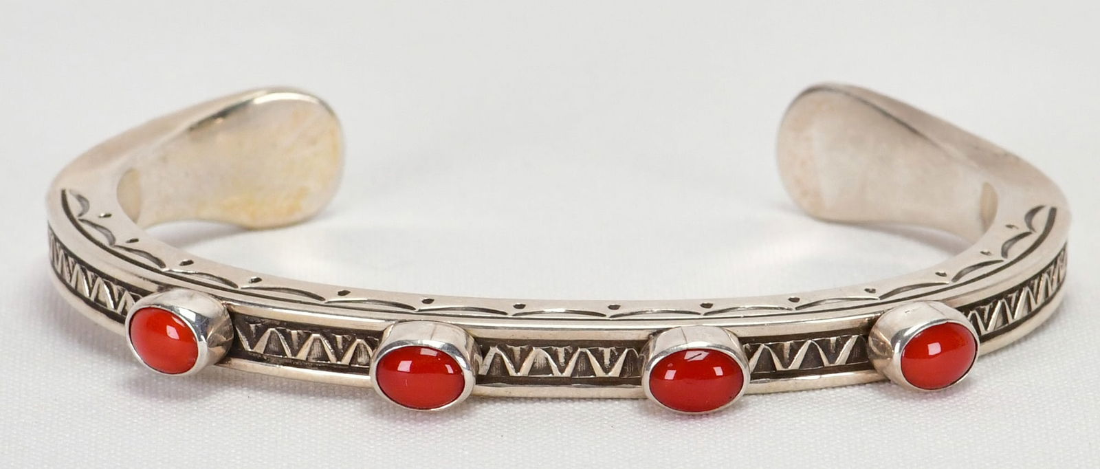 Landon Secatero Sterling Silver Mediterranean Coral Cuff Bracelet: Sterling Silver| Landon Secatero Sterling Silver Mediterranean Coral Cuff Bracelet| Genuine Mediterranean Coral| This piece has a heavy stamped band with 4 Natural Mediterranean Coral Cabochon Pieces