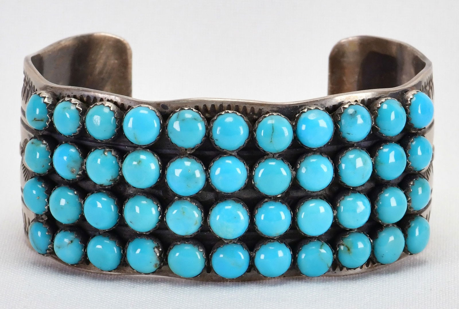 Leroy James Sterling Silver Sleeping Beauty Turquoise Cabochon Bracelet: Sterling Silver| Leroy James Sterling Silver Sleeping Beauty Turquoise Cabochon Bracelet| Genuine Sleeping Beauty Turquoise| This piece has 44 Matched and Polished Turquoise Stones across the top| Ins