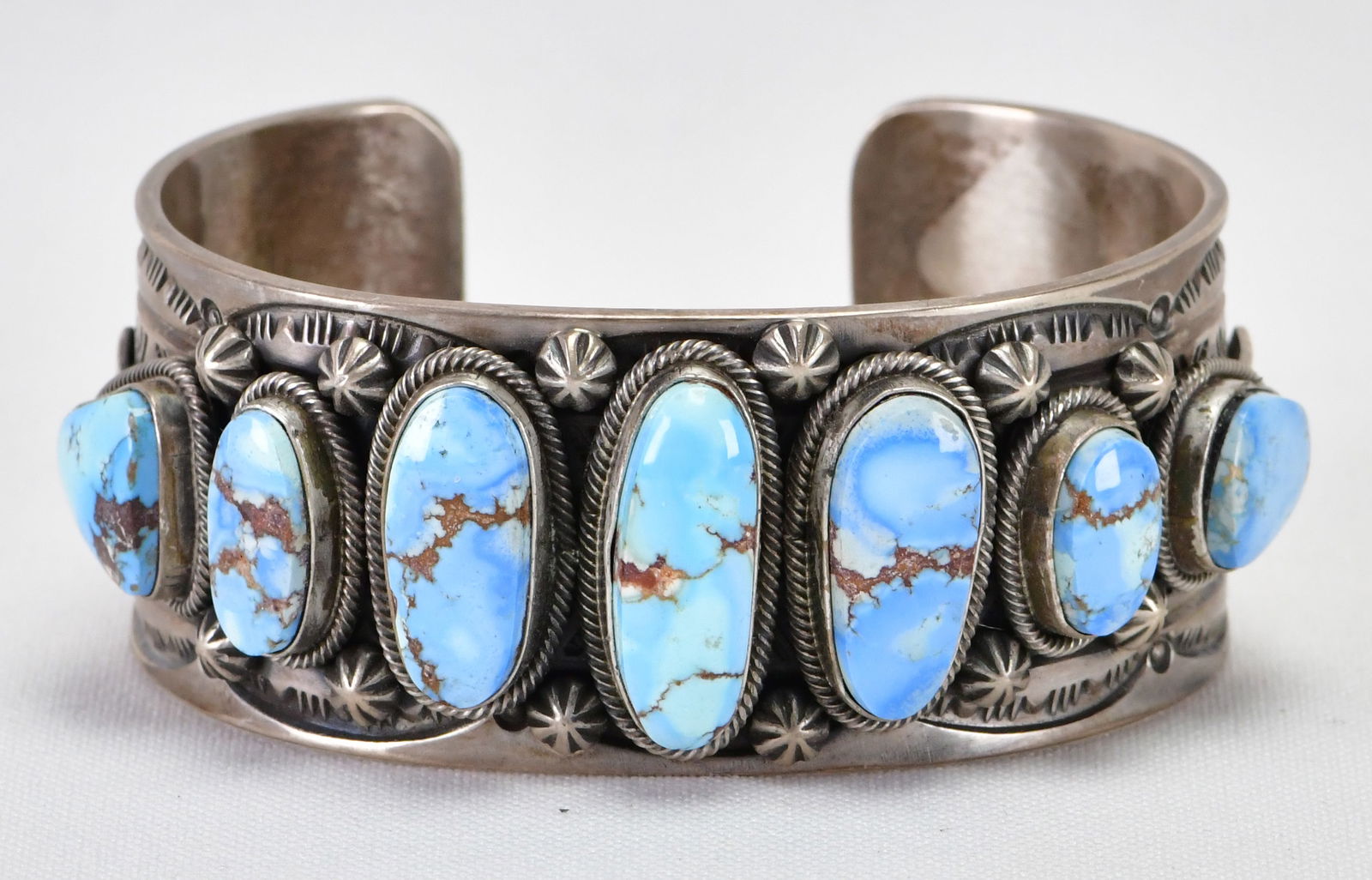 Fred Maloney Sterling Silver Golden Hills Turquoise 7 Stone Cuff Bracelet: Sterling Silver| Free Maloney Sterling Silver Golden Hills Turquoise 7 Stone Cuff Bracelet| Genuine Golden Hills Turquoise| Inside measures 5.75" plus a gap of 1" - Total 6.75"| Face Width 1 1/8"| Ins
