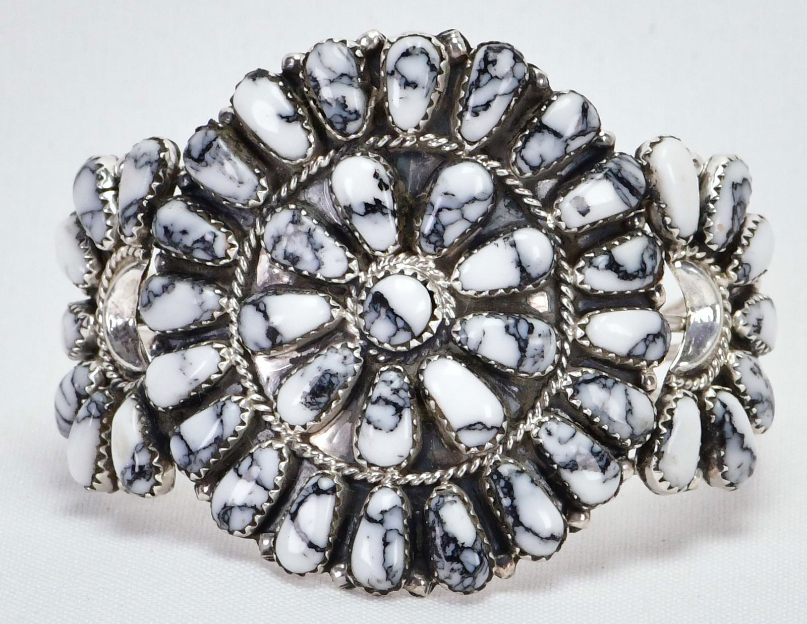 Native American Sterling Silver White Buffalo Block Turquoise Cluster Cuff: Sterling Silver| Native American Sterling Silver White Buffalo Block Turquoise Cluster Cuff| Block Turquoise| Inside measures 5.75" plus a gap of 1.25"- Total 7"| Face Width 2"| Hallmarked "JP" for Ju