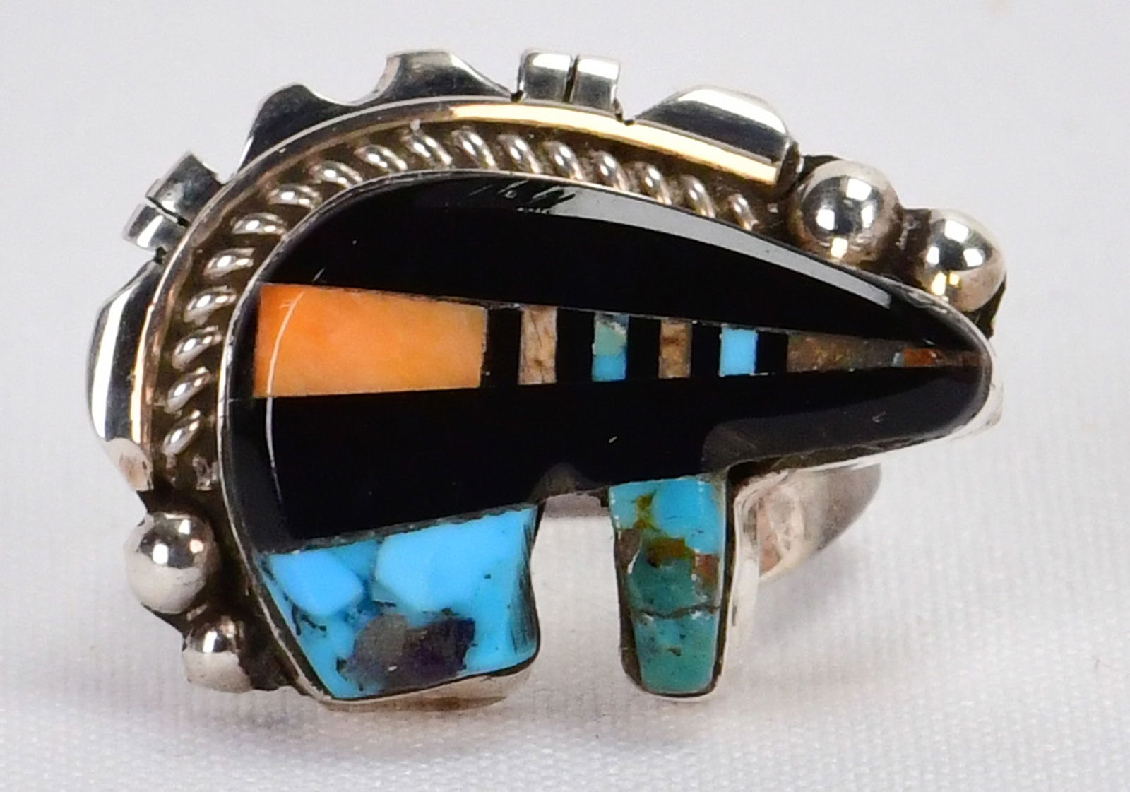 Navajo, Ray Jack Sterling Silver Turquoise & Jet Inlay Bear Ring - Size 7.5: Sterling Silver| Navajo, Ray Jack, Sterling Silver Turquoise and Jet Inlay Bear Ring| Genuine Turquoise, Genuine Jet. Spiny Oyster| Measures 3/4" Tall x 1 1/8" Wide| Signed| Weighs 9.6 Grams| Size 7.5