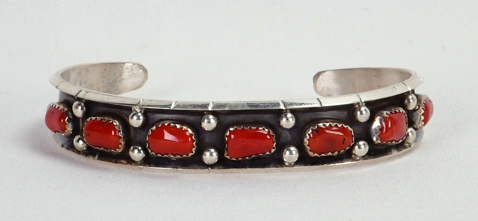 Native American Sterling Silver Coral Cuff Bracelet: Sterling Silver| Native American Sterling Silver Coral Cuff Bracelet| Genuine Coral| Inside measures 5.75" plus a gap of 1" - Total 6.75"| Face Width 3/8"| Hallmarked "RC"| Weighs 19.9 Grams| Native A