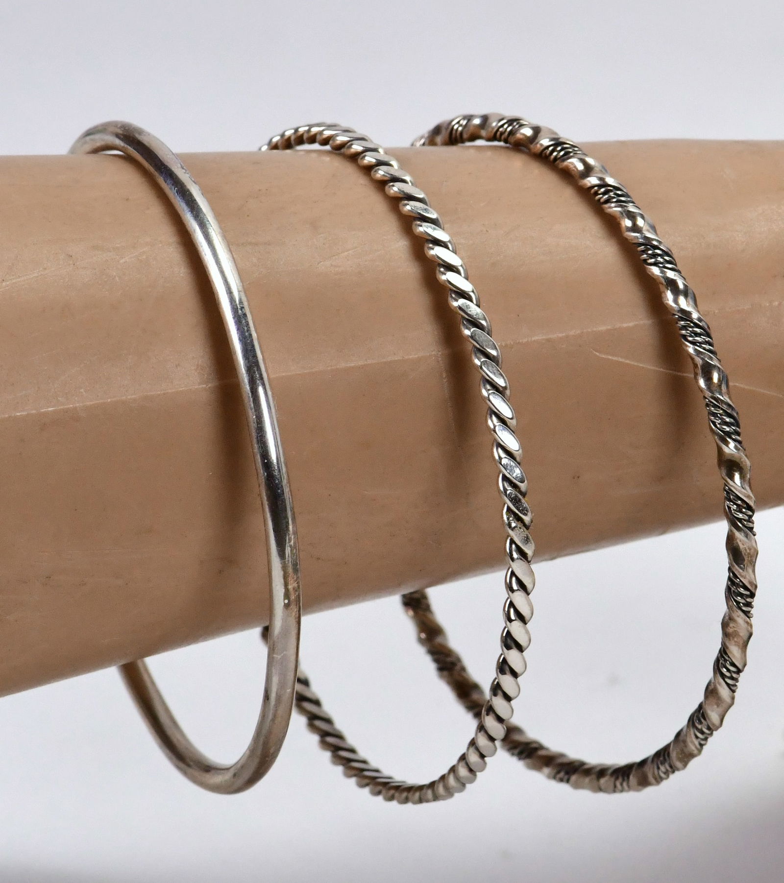 Caroline Tsosie Vintage, Sterling Silver Set of 3 Bangles: Sterling Silver| Caroline Tsosie Sterling Silver Set of 3 Bangles| All Sterling Silver| Measures 3" in Diameter| 1 Twisted Wire, 1 Plain and 1 Braided piece| Unsigned| Weigh 41 Grams| Great for Stacki