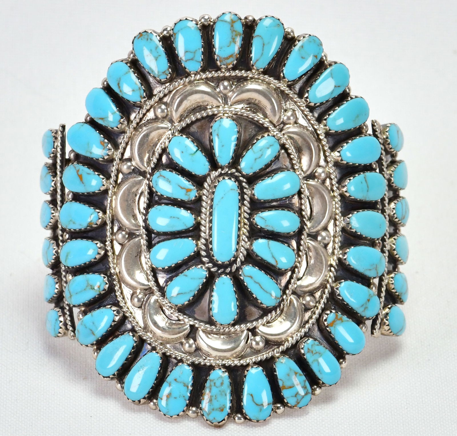 Tina Ben, Navajo, Sterling Silver Block Turquoise Repousse Cuff Bracelet: Sterling Silver| Tina Ben, Navajo, Sterling Silver Block Turquoise Repousse Bracelet| Block Turquoise| Inside measures 5.75" plus a gap of 1.25" - Total 7"| Face Width 3"| Hallmarked "TB:| Weighs 44 G