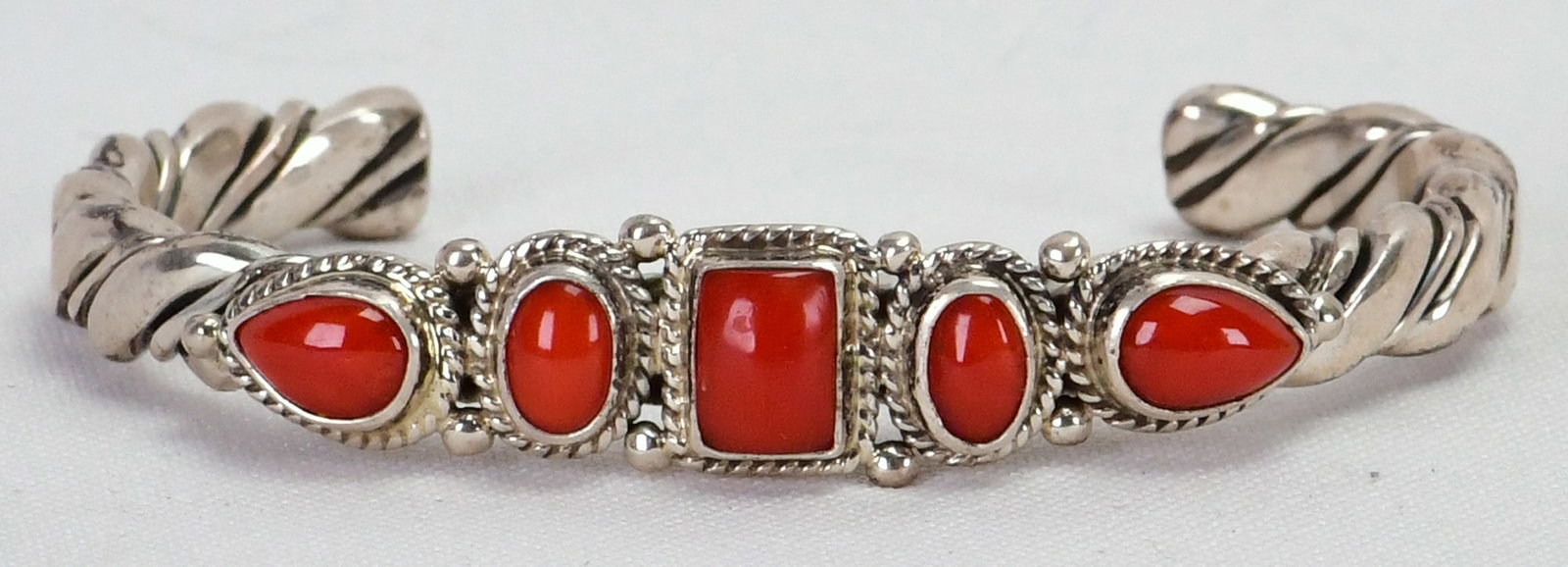 Zuni, Sterling Silver Mediterranean Coral 5 Stone Twisted Wire Bracelet: Sterling Silver| Zuni, Sterling Silver, Mediterranean Coral 5 Stone Twisted Wire Cuff Bracelet| Genuine Mediterranean Coral| Inside measures 5" plus a gap of 1.25" - Total 6.25"| Face Width 1/4" Wide|