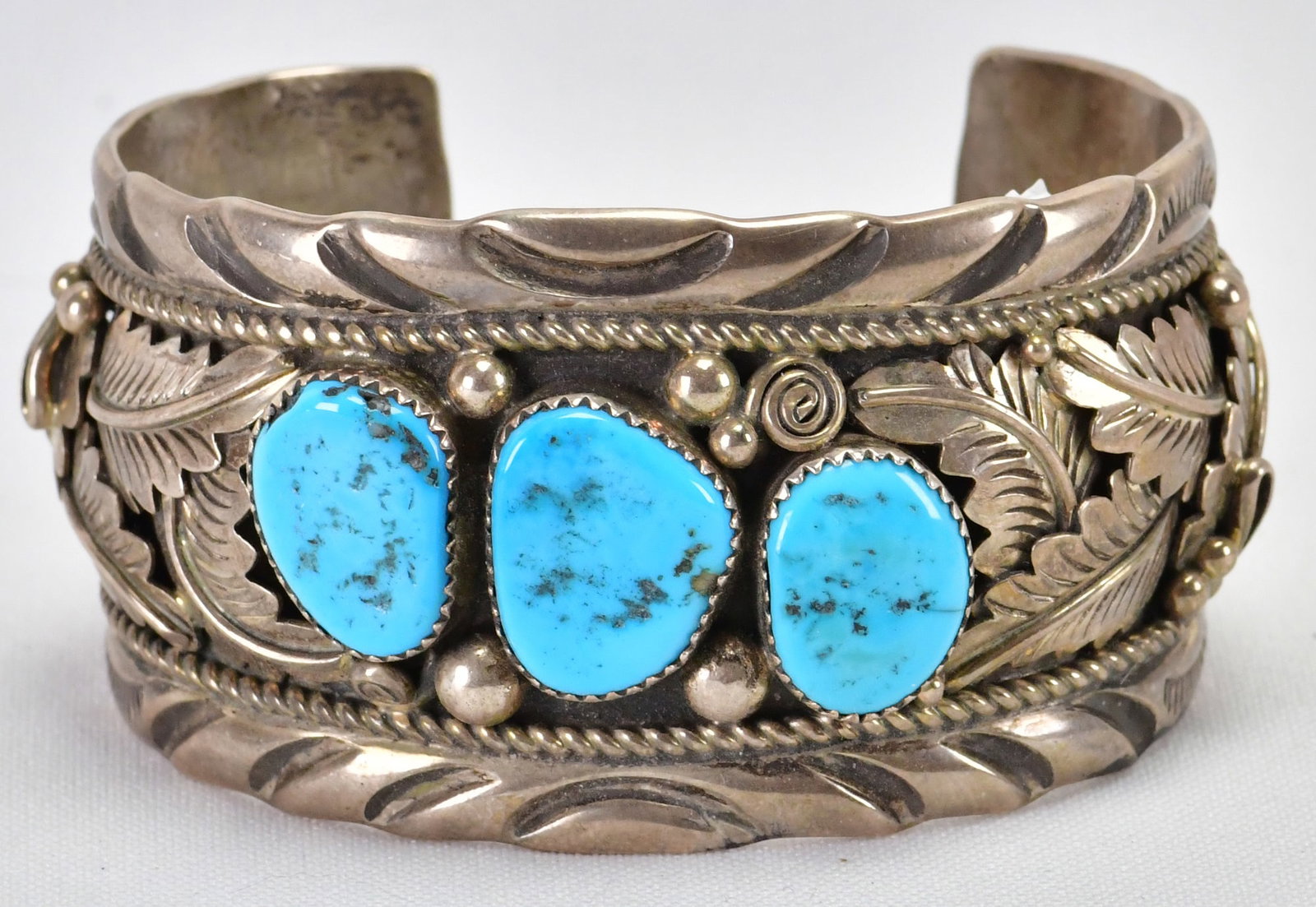 Julia Etsitty Sterling Silver Vintage Kingman Turquoise Ornate Cuff: Sterling Silver| Julia Etsitty Sterling Silver Vintage Kingman Turquoise Cuff w/Ornate Detail| Genuine Kingman Turquoise| Inside measures 6" Plus a gap of 1.25"- Total 7.25"| Face Width 1.5"| Has Orna