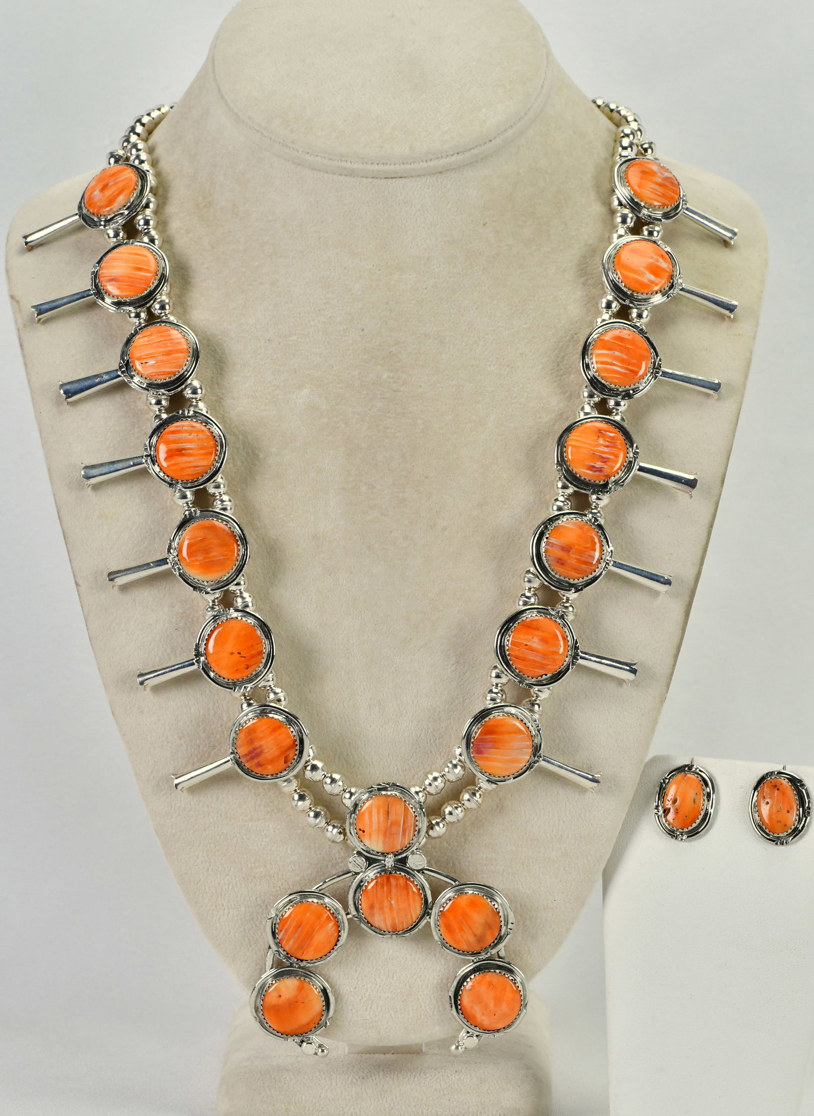 Native American Sterling Silver Spiny Oyster Squash Blossom Necklace Set: Sterling Silver| Native American Sterling Silver Spiny Oyster Squash Blossom Necklace Set| Genuine Spiny Oyster| Necklace measures 23" in length {Without the Naja Drop}| Has 7 Blossoms on Each Side th