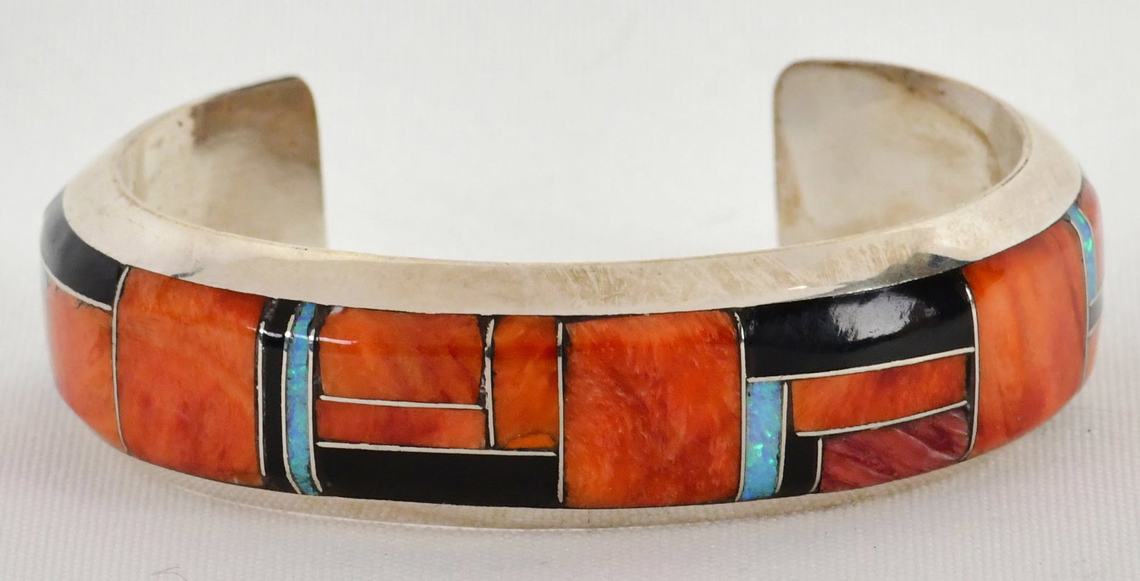 Native American Sterling Silver Multi-Stone Inlay Cuff Bracelet: Sterling Silver| Native American Sterling Silver Multi-Stone Inlay Cuff Bracelet| Genuine Turquoise, Spiny Oyster and Jet| Inside measures 5 1/8" plus a gap of 1 1/8" - Total 6.25"| Face Width 5/8"| H