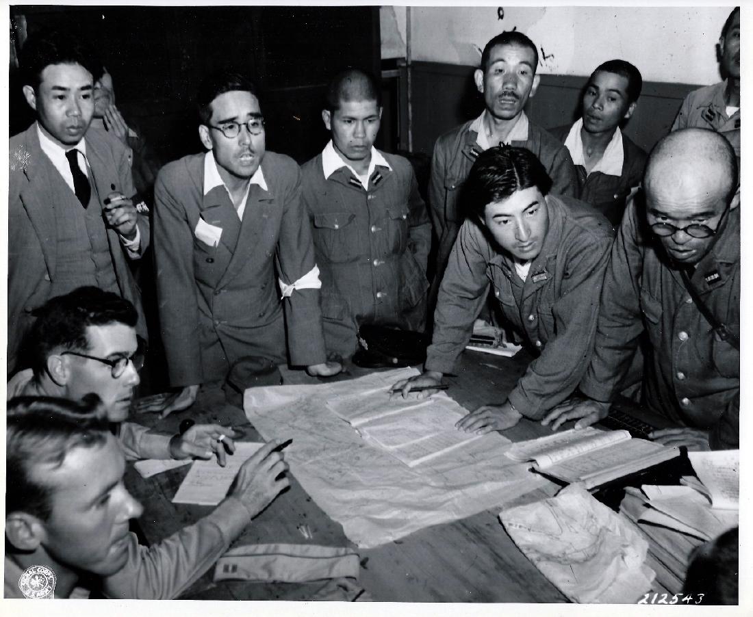 Yamato Airfield Command Surrendder, 1945 Honshu, Japan: 1945 Original Authentic W.W.II. U.S. Signal Corps Photo 212543. Commander of the Yamato Airfield, Northern Honshu, Japan, together with Japanese Pilots, discusses Surrender Terms of the field with Cap