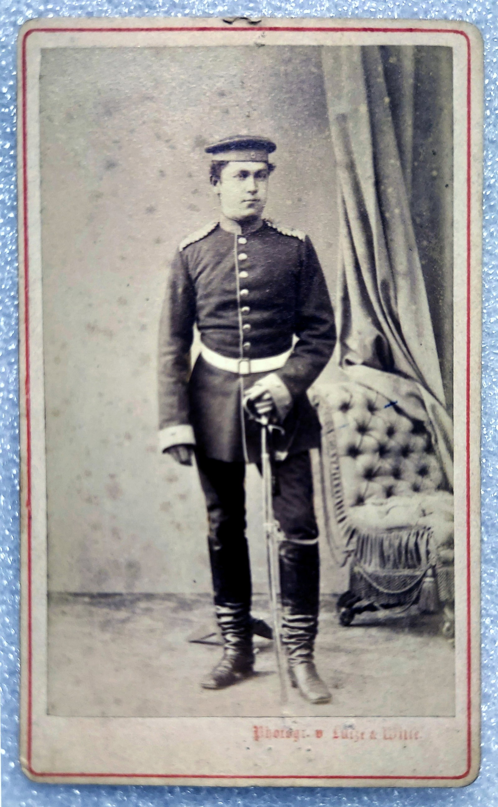 Photograph 1873: French-Prussian War Soldier in Prussian Uniform: 1873 Photograph of the American man in Prussian uniform during the French-Prussian war. Dimensions: 3 x 4 inches, mounted on printed photographer's cardboard. Inscribed in English: "Presented to my fr