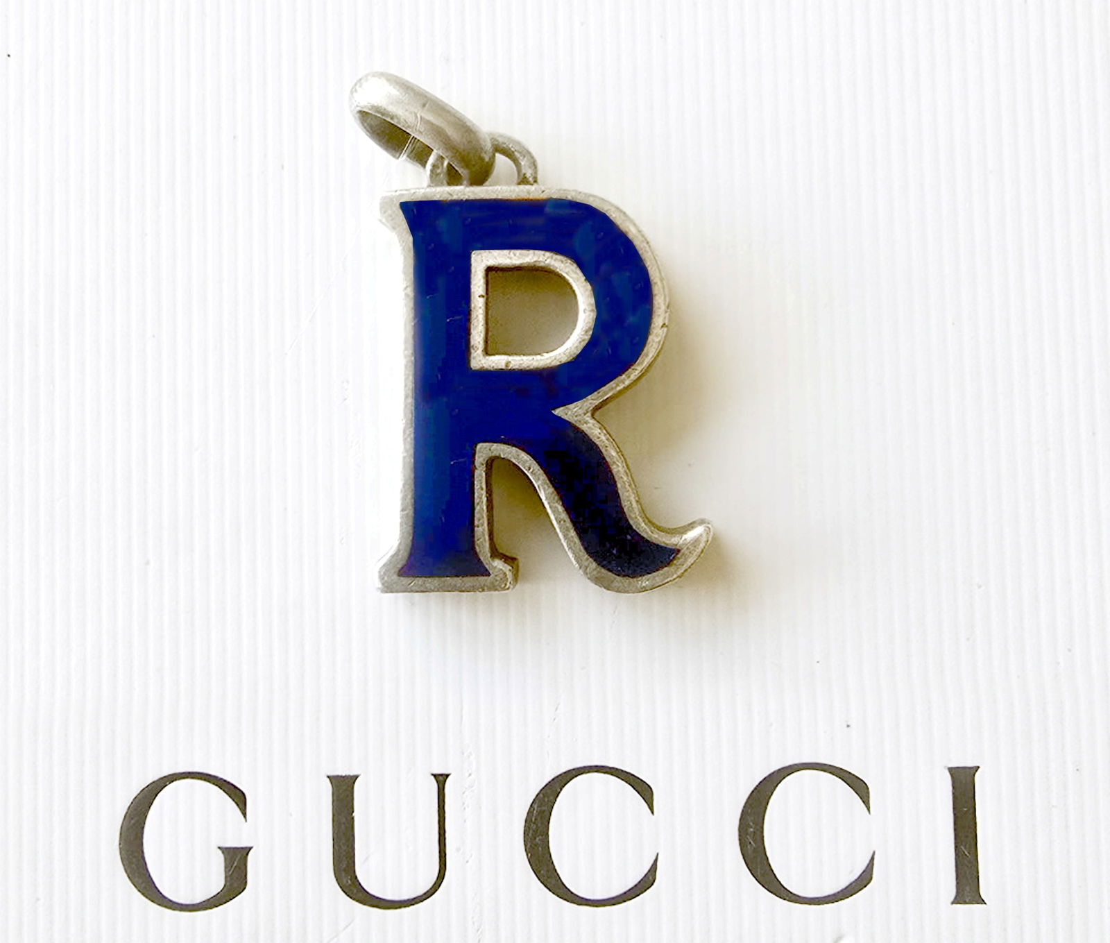 Gucci Silver & Navy Blue Enamel Letter R Pendant 1975 London UK: Gucci silver and blue enamel initial R pendant, in 3-dimensional form, stamped Gucci, hallmarked E.J. Ltd, London c.1975. Dimensions 1.5 x 1 x 0.25 inch, Weight 22g.
