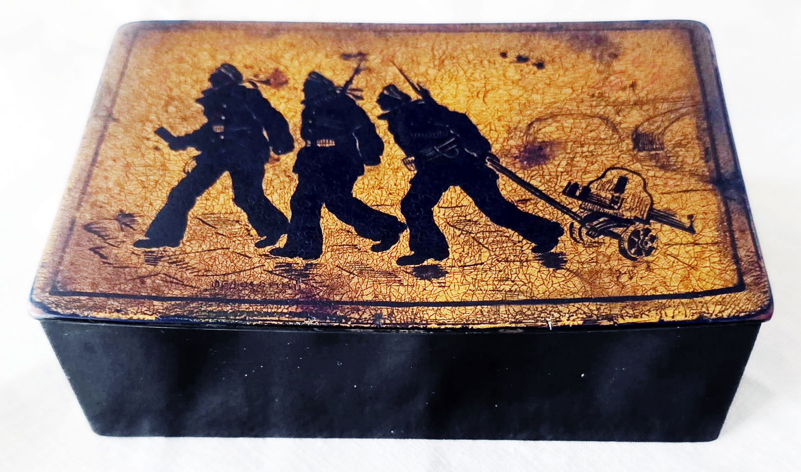 Russian Fedoskino Box with Silhouette Painting: October, c.1928: Exceptionally rare Fedoskino box, featuring a silhouette painting of armed Baltic Navy sailors during a Russian 1917 Revolution with Petrograd on the background. The papier-mâché base, black