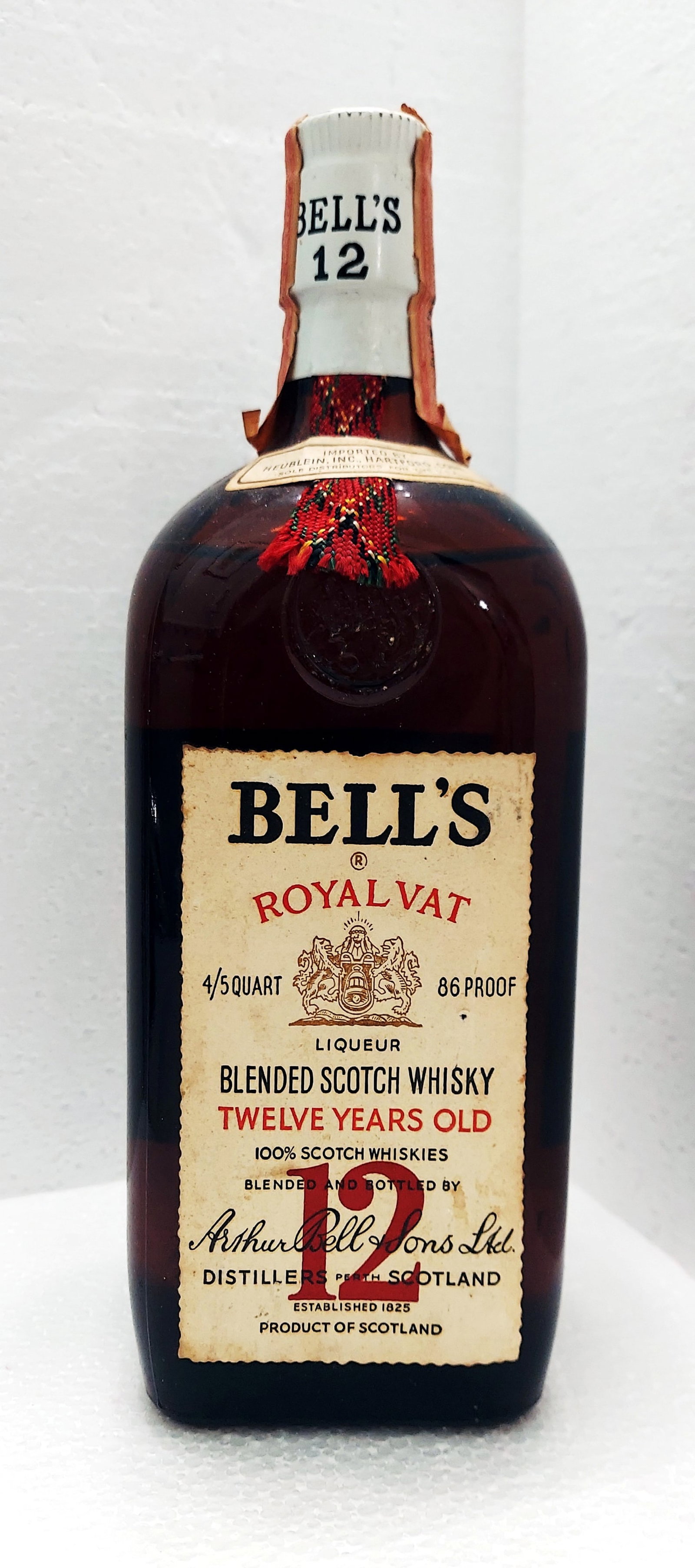 Bell's Royal Vat: 12-years-old 4/5 Qt, 1960s: Bell's 12-years-old, 4/5 Qt, 1960sRoyal vat rectangular bottle with white label and white cap. The excise strip series 112 issued in 1961 to 1977. Distiller: Arthur Bell & Sons Ltd., Perth Scotland. 8