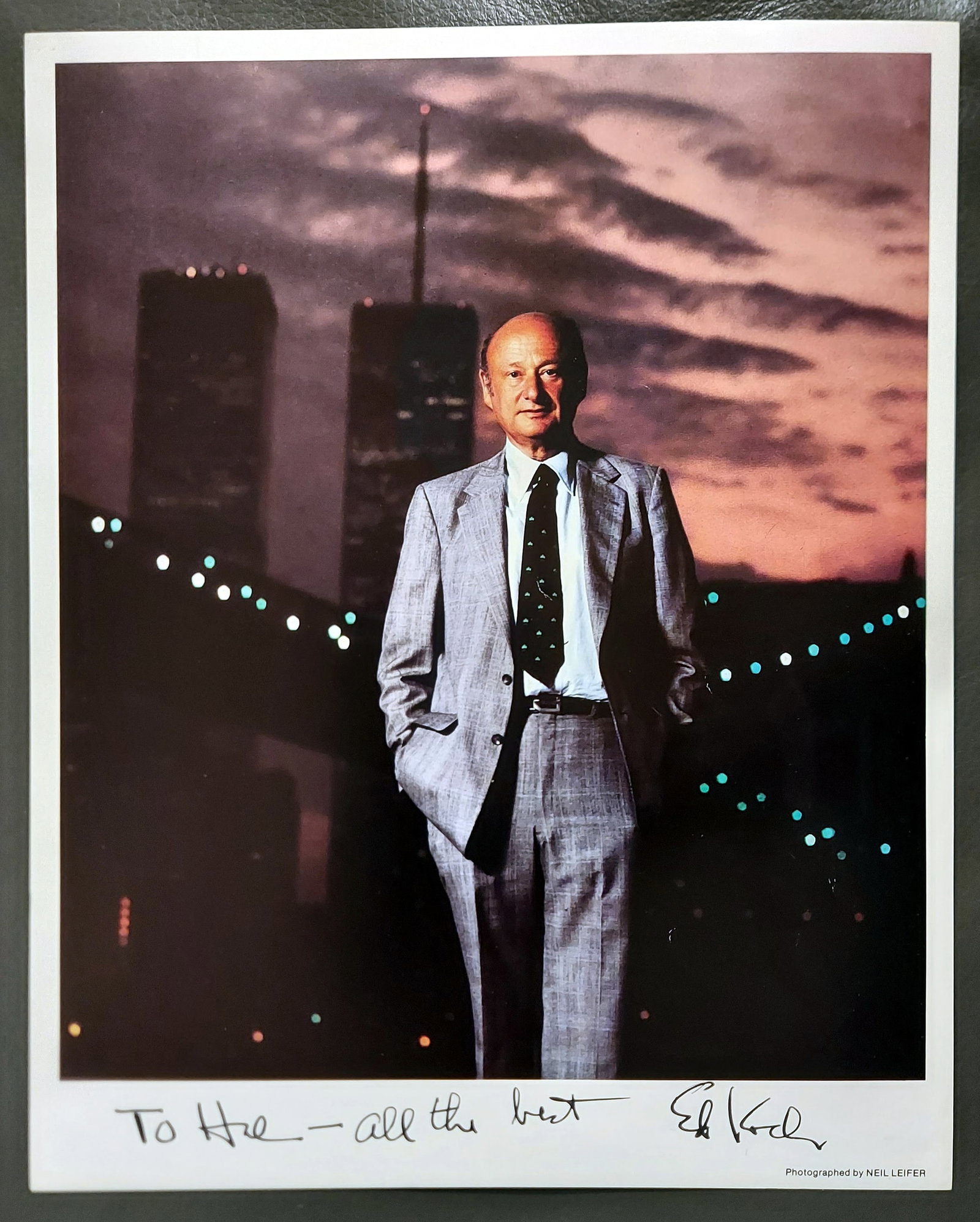 Neil Leifer: NYC Mayor Ed Koch Signed, Inscribed 1980 Silver Gelatine Print: New York City Mayor Ed Koch (1924 – 2013) during sunset in front of the Brooklyn Bridge in 1980. Inscribed and hand-signed by Ed Koch: To Hal - all the best Ed Koch. Dimensions: 8 x 10 inches, n