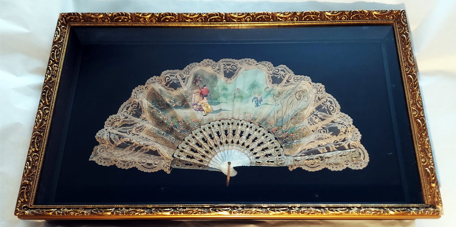 Decorated Fan: Painted Garden Date, Openwork Mother-Of-Pearl Ribs: Hand Fan with a hand-painted garden scene of a young pair on a date, openwork mother-of-pearl sticks with floral decorations, laces, and inlaid metal leaf. Signed by artist on the center-right: Andfru