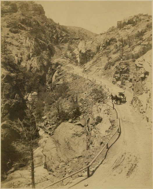 [PHOTOGRAPHY]. JACKSON, William Henry. “Ute Pass”: 488. [PHOTOGRAPHY]. JACKSON, William Henry. “Ute Pass,” view of a scene in Colorado (Ute Pass, Teller County) showing a road through the pass with a horse and surrey with fringe on top, wi