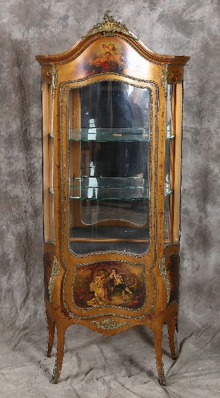 Serpentine Vernis Martin Vitrine: LXV style serpentine bronze mounted gilt wood mirrored back cabinet with hand painted cupid decoration and bronze mounts. Age: First Quarter 20th Century Condition: Good: Some soiling and losses to th
