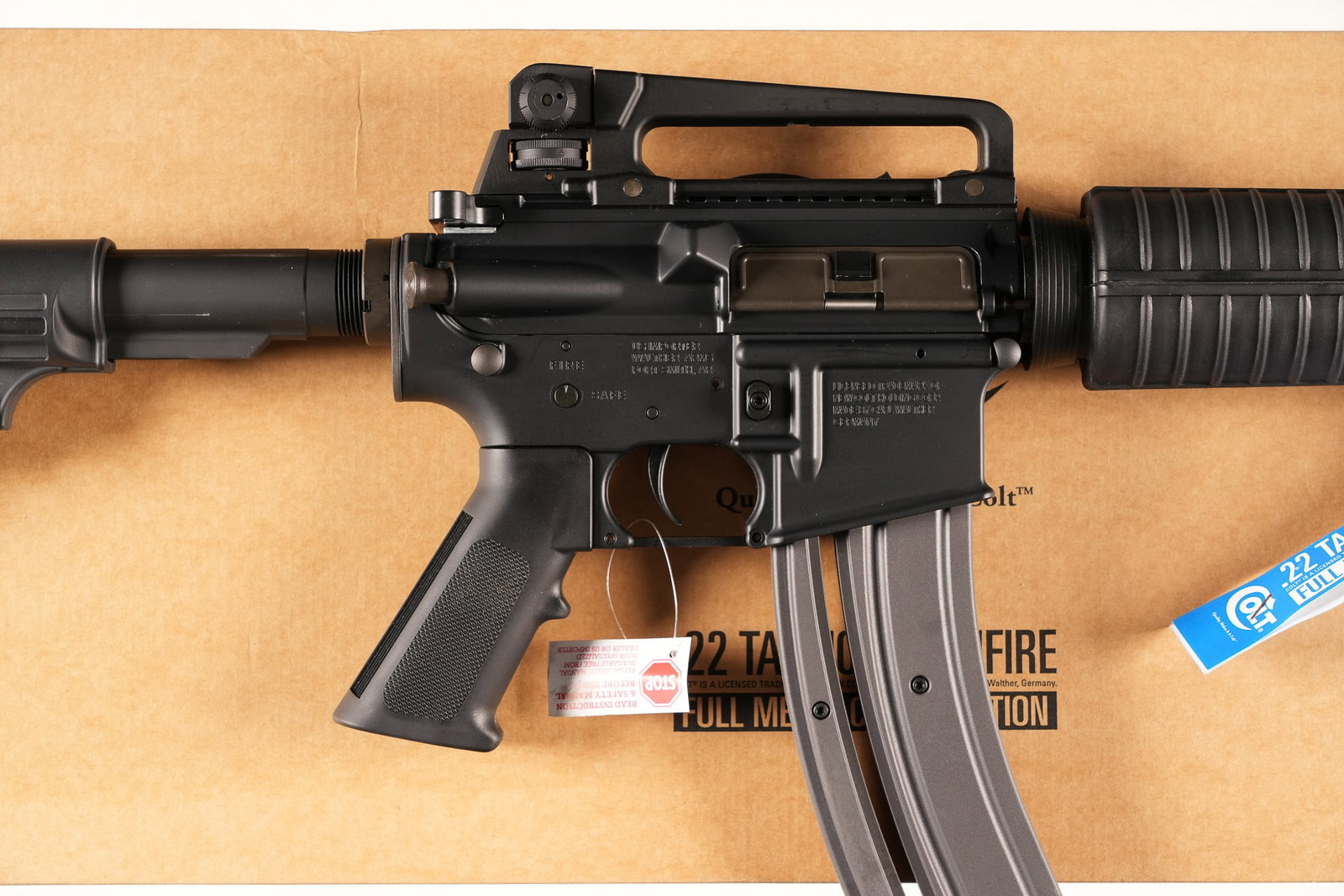 A4936 Colt Tactical Rimfire M4 Semi Rifle .22lr: .22lr Serial # WJ022688 Colt Tactical Rimfire M4 22 LR semi Auto carbine with detachable carry handle rear sight, cage flash hider and 30 round magazine In factory box numbered to gun with factory pap