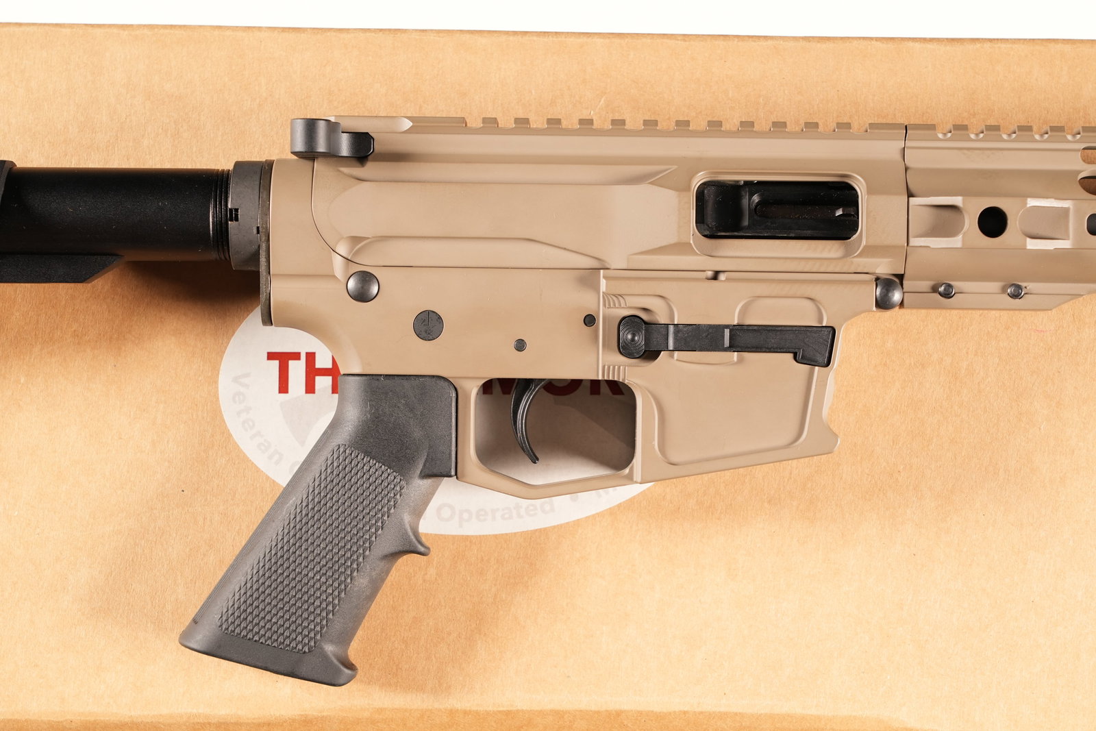 The Armory TA9 Pistol 9mm: 9mm Serial # TA1596 The Armory Pelham AL, TA9 AR Platform pistol with tan finish, 7" rail system and flat top receiver. Uses Glock magazines. Retractable Pistol brace stock with cage flash hider. Cond