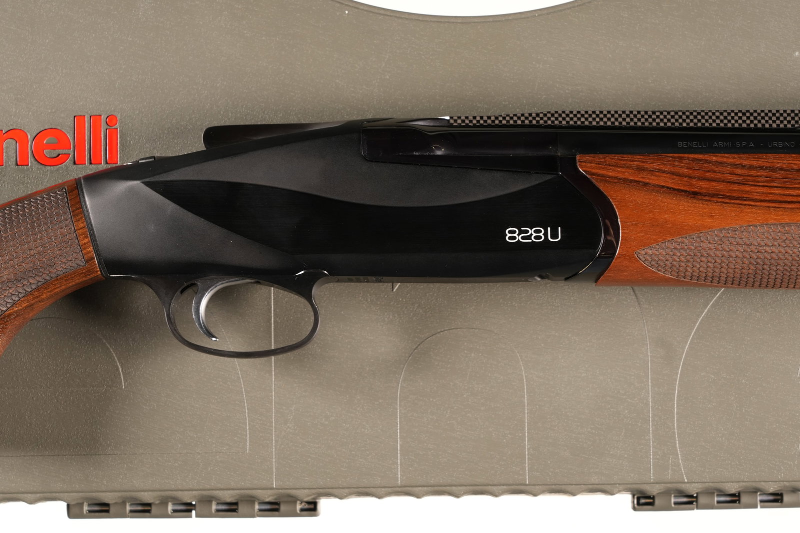 Benelli Urbino 828U O/U Shotgun 12ga: 12ga Serial # BS006085B15 Benelli Model 828U 12 Ga with 28" Carbon Fiber vent rib, 3" chamber with single selctive triggers. Interchangeable chokes (5 included with stock adjustment shims and accessor