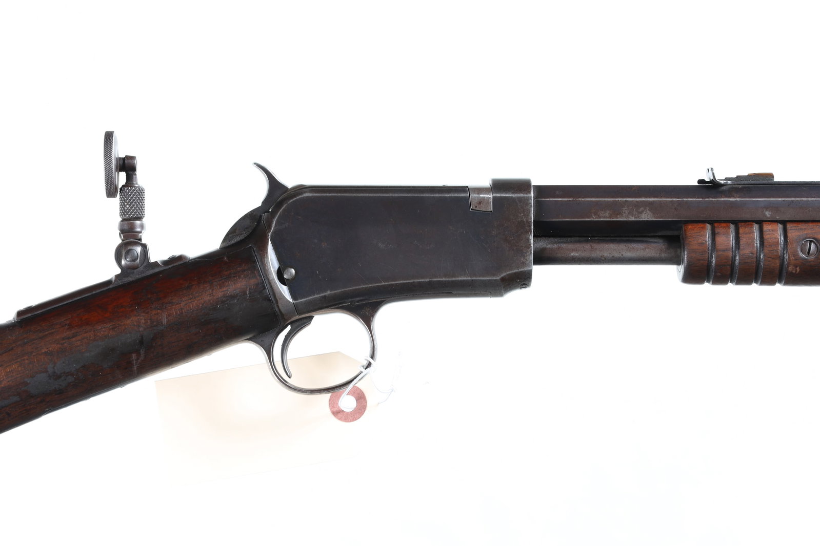 Winchester 1890 Slide Rifle .22 short: .22 short Serial # 423322A Good to very good overall condition. Features a ghost ring front sight and rear peep sight. Barrel 24" C&R. The Winchester Model 1890, designed by John Browning and produced