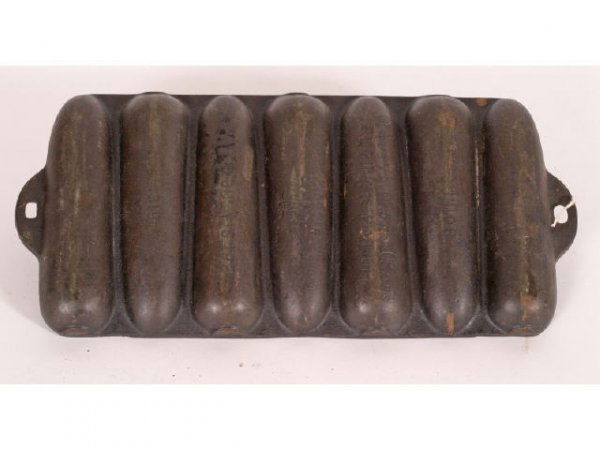 Wagner Ware cast iron corn stick pan: Wagner Ware cast iron corn stick pan; marked Junior- Rusty Korn Kobs-Reg in US Pat Off-Wagner Ware Sidney-0-Patd July 6, 1920-1319D; 13inches x 6inches Live auction by Montrose Auction, Inc. Establish