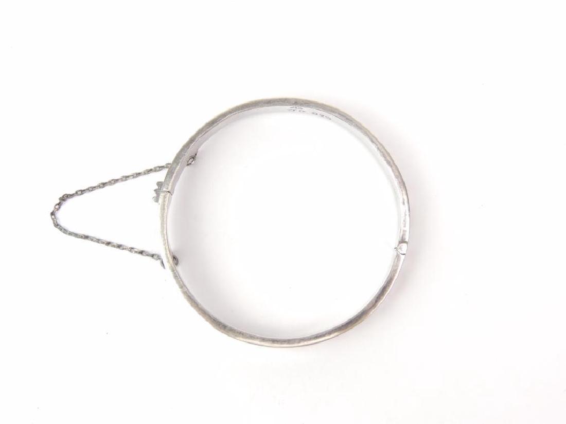 Sterling Silver Bangle Bracelet - signed "JG": Sterling silver bracelet is secured by a clasp and safety chain