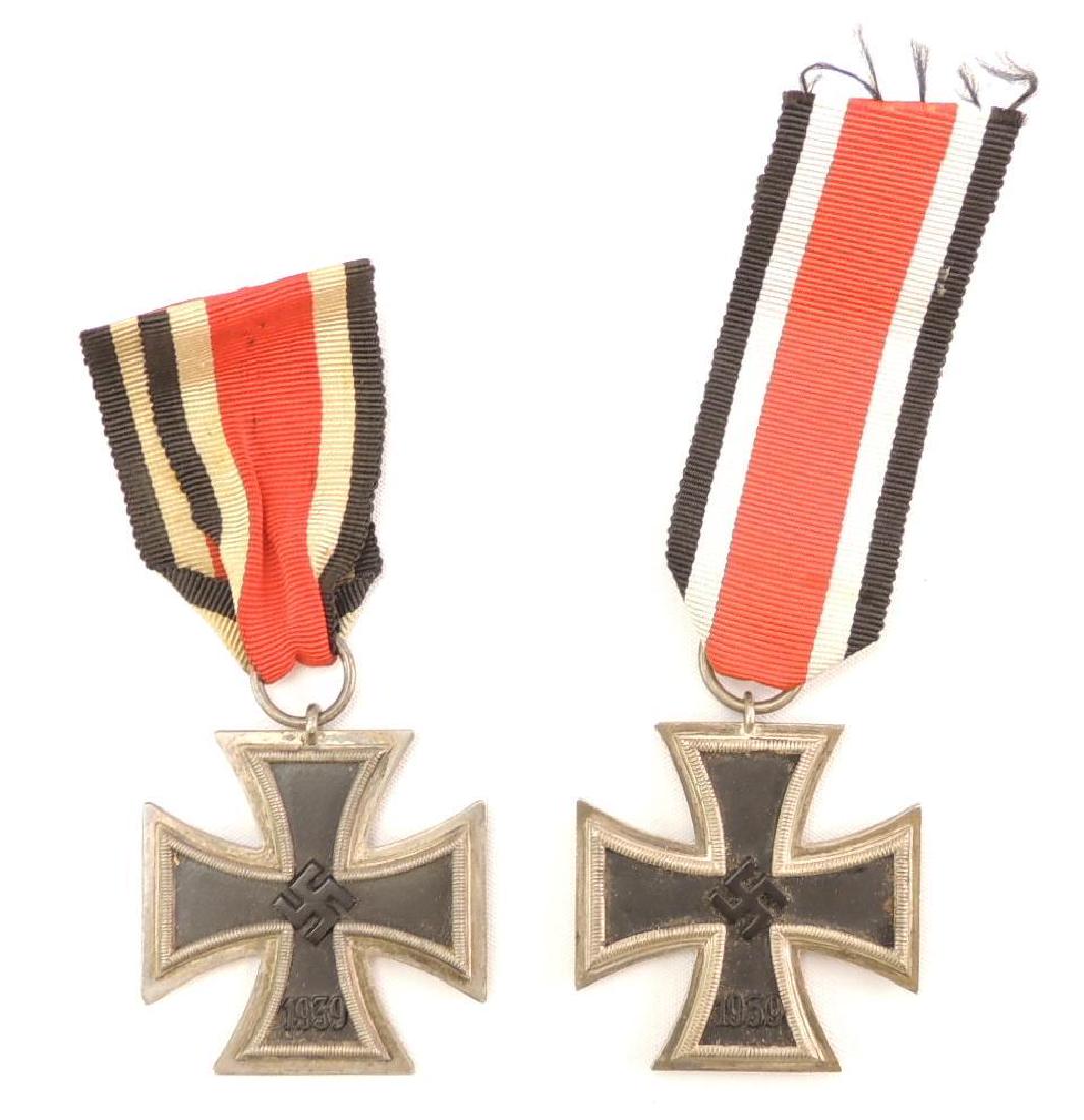 Group of 2 WW2 German 2nd Class Iron Crosses with: Lot consists of two Iron Cross 2nd Class Medals showing wear/age with minor wear/age to black enamel. Both crosses are are magnetic and come complete with suspension rings and ribbons. 1 3/4"x1 3/4"