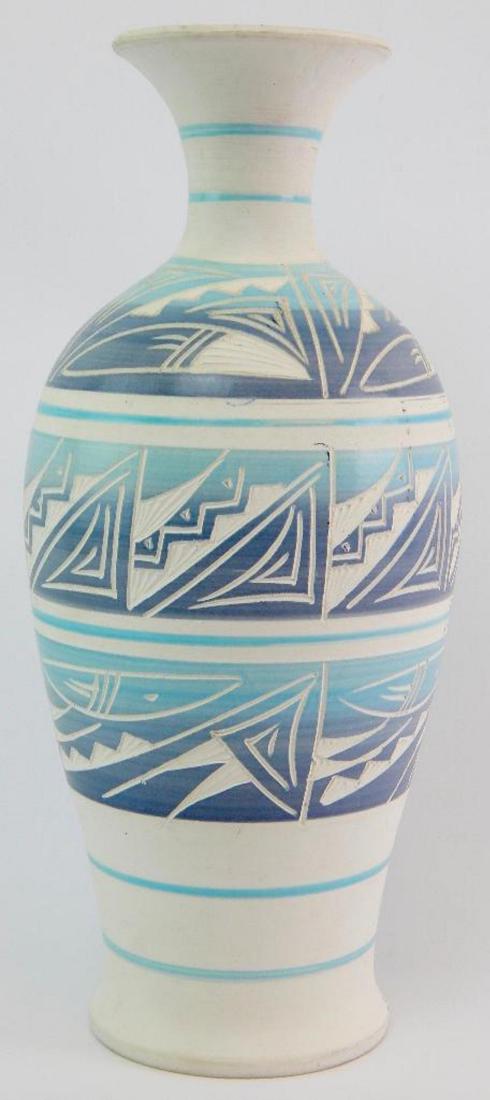 Tall Carved Southwestern Vase - Signed: 13 x 5-1/2 x 5-1/2. Sky blue and storm gray overpainting on carved white surface w/ glazed interior. Signed by the artist, "R. Gonza".