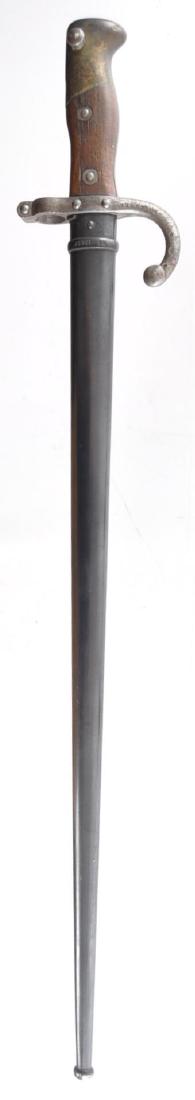 French M1874 Bayonet with Scabbard: Serial Number M53586, Overall length in scabbard is 26inches, Armes de St. Etienne, June 1879, for 11mm Gras Rifle. Blade in 20 1/2 inches, clean, no rust, no nicks. Haft is 4 1/2 inches, wood with ir