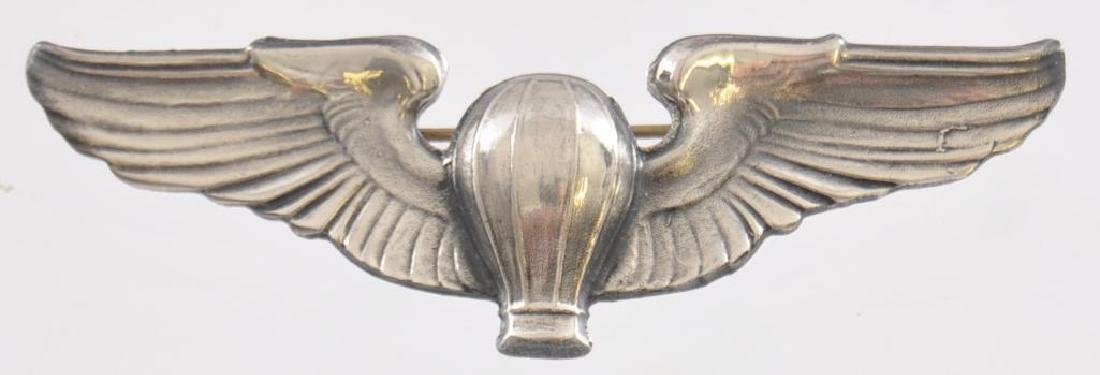 WW2 USAAF Army Air Force Balloon Dirigible Pilot Wing.: Measures 3 3/16 wide by 1 tall. The front shows a balloon in the center flanked by a wing on each side. The reverse is maker marked Meyer New York in their shield logo. It is also marked Sterling . Ha