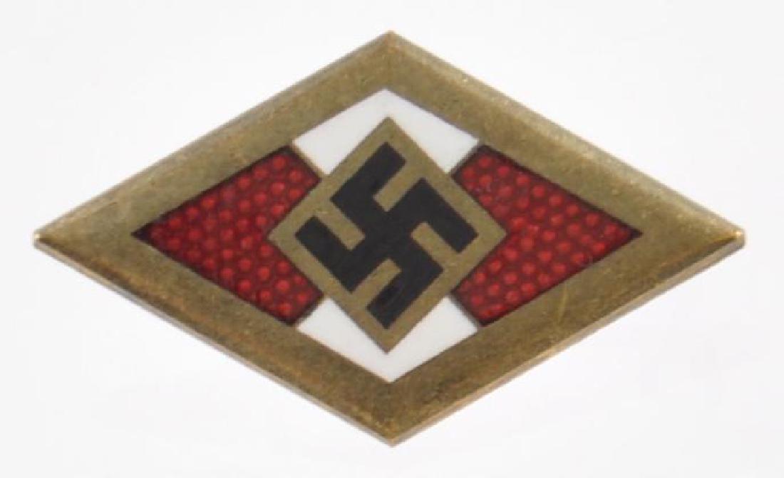 WW2 German Golden Hitler Youth HJ Badge of Honor.: Measures 11/16 wide by 1 1/8 tall. The front shows a swastika in the center of a diamond with a brass frame. The reverse side is maker marked RZM M1/70 ges gesch . It is also numbered 9518 . Has a thi