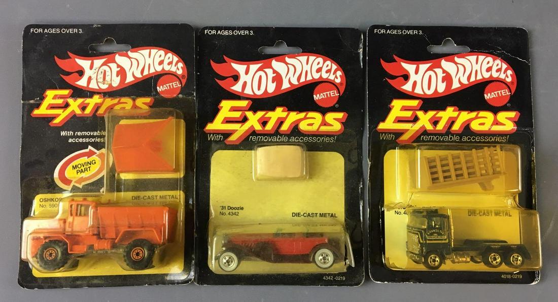 Group of 3 Hot Wheels Extras Die-Cast Vehicles In: By Mattel, includes Oshkosh snow plow, 1931 Doozie and ford stake bed truck some damage on package of ford truck
