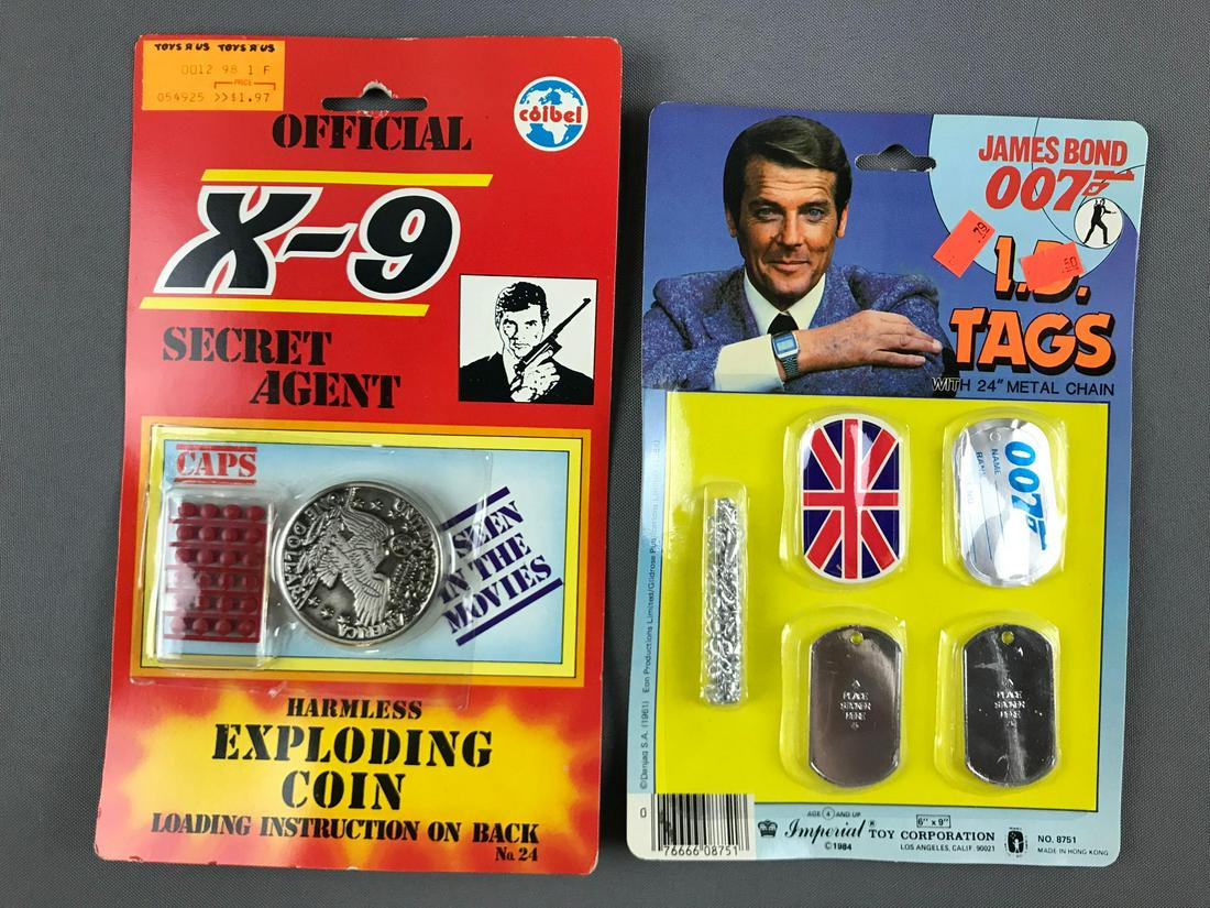 Group of 2 James Bond Toys In Original Packaging: Exploding coin, ID tags
