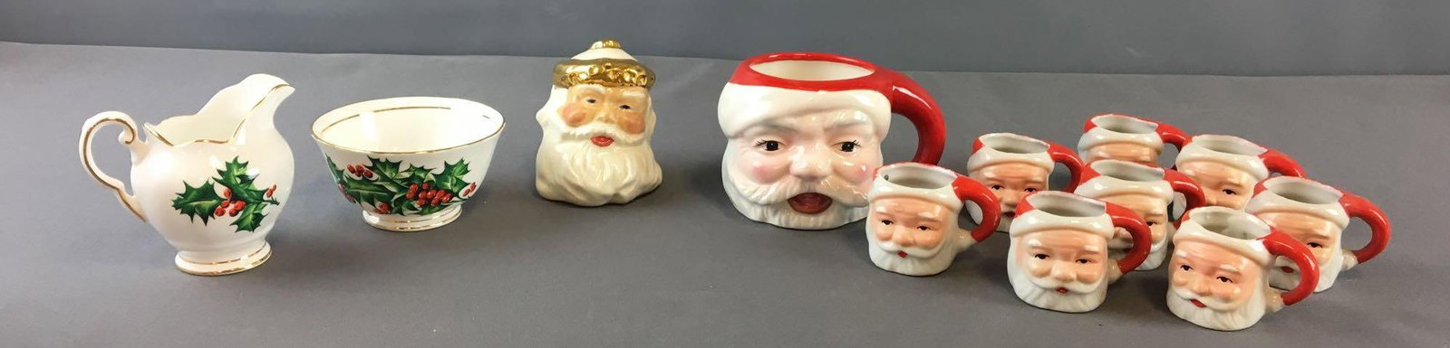Group of Christmas Cream and Sugar and more: Includes Santa Head cups one big 8 miniature, Santa Head salt shaker and December holly cream and sugar