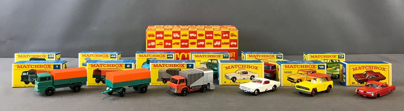 Group of 12 Matchbox Diecast Toy Cars in Gift Pack Box: Numbers 1,2, 7, 8, 18, 22, 45, 49, 50, 70, 73. In original gift pack box. Individual car boxes appear unopened. A Lesney Product.