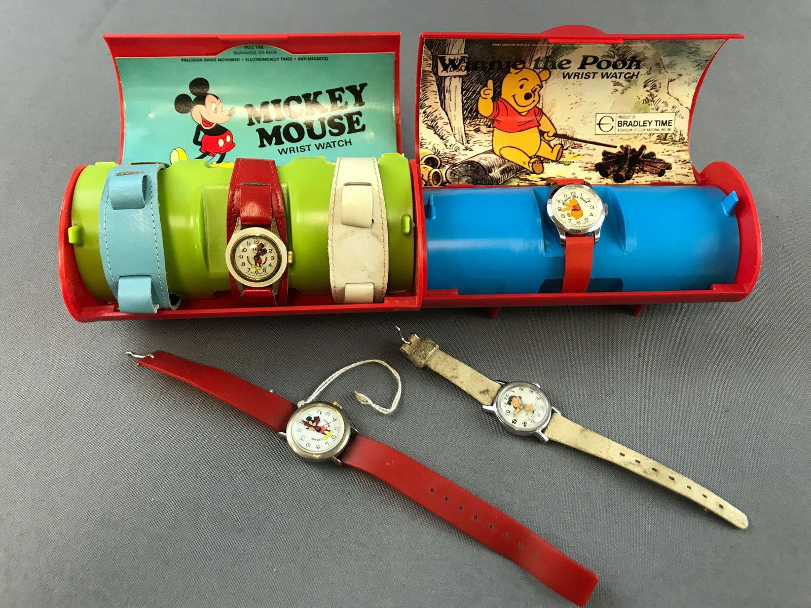 Group of 4 character watches: Peanuts Lucy, Winnie the Pooh, 2 Mickey Mouse: one with 2 extra watchbands