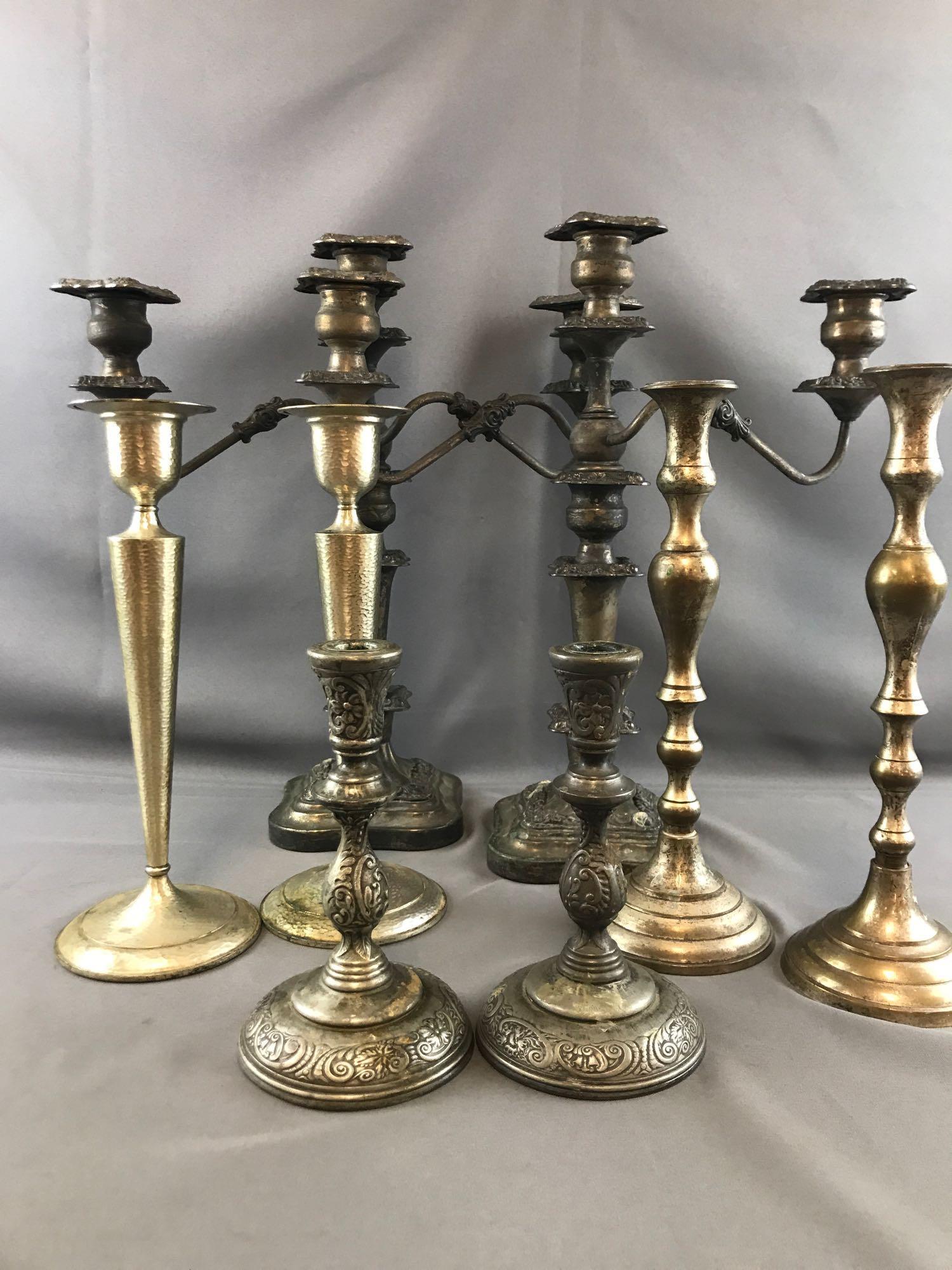 4 sets of silver plated candlesticks: 8.25 inch set marked Pairpoint Mfg Co. Bedford Mass 12.5 inch set marked Sheffield Design, Made in U.S.A. 13.2 inch set unmarked, Made in India tag 18x16.5 inch set markings unclear, 3 candle