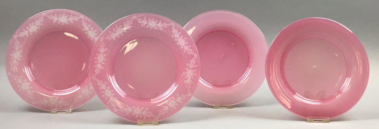 Lot of 4 : Steuben Rosaline Art Glass Plates -: Two of the Steuben plates in this lot (Carder design #2028) are signed and measure 8-1/2 inches and feature acid-etched Rosaline over Alabaster floral swags. The remaining Rosaline plates are smaller,