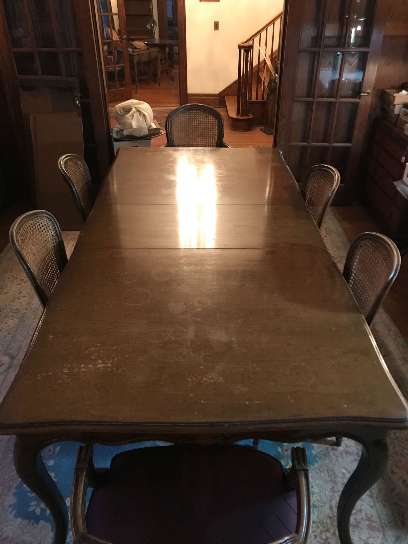Antique Dining Table and 6 Chairs: Has additional leaf and table cover. No shipping or transportation available. 2 arm chairs, 4 without. Table has some marks on top, needs to be refinished. Chairs have cushions but seats need repaired