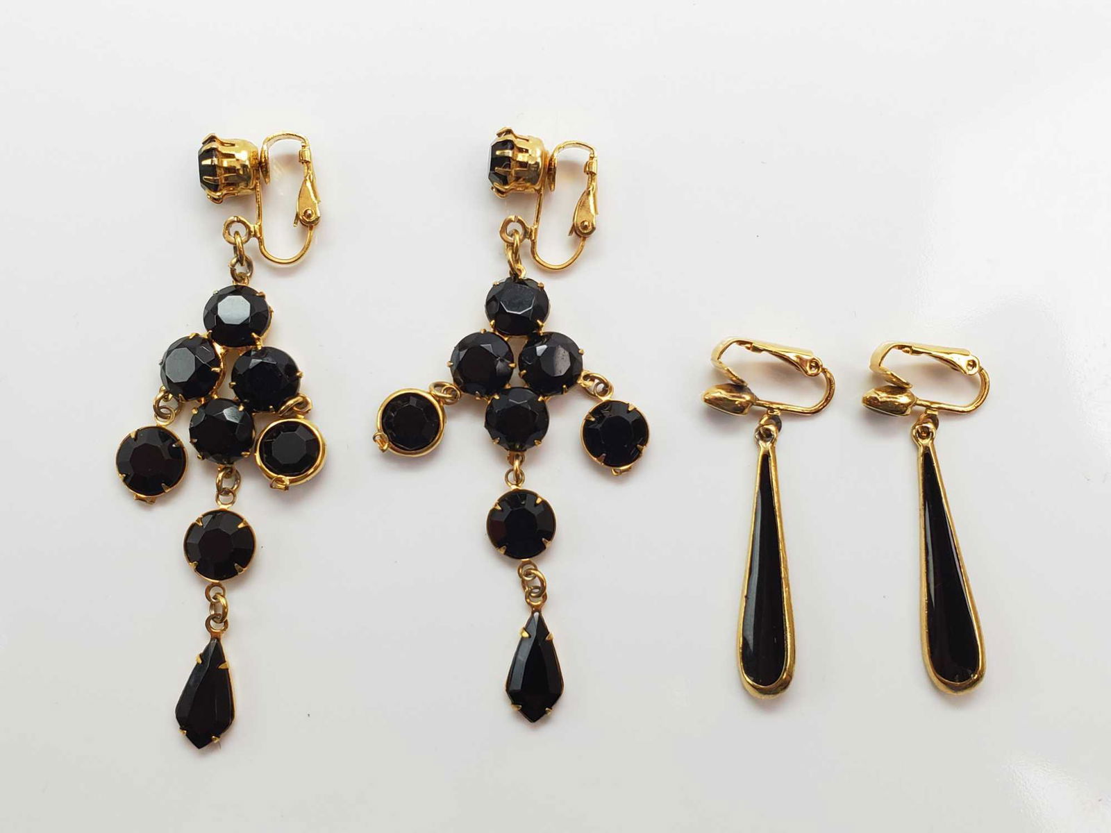 Pair of Gold and Black Earrings: The longer, chandelier-style has a 3-1/4 inch drop; The shorter pair has a 1-5/8 inch drop. Both pair are designed for nonpierced ears