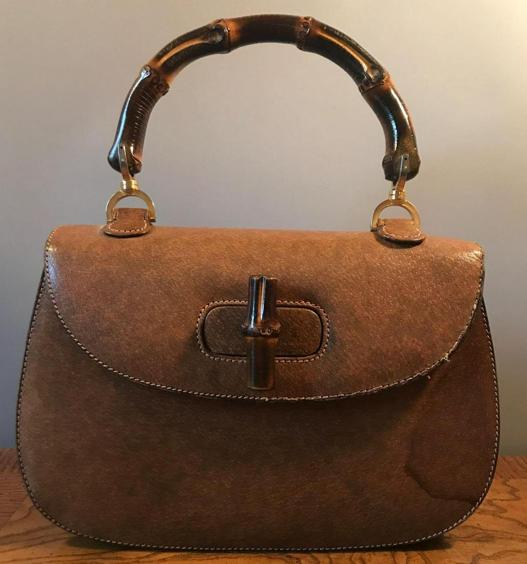 Vintage Gucci handbag: 10.25x2.5x7 inches. Brown leather, bamboo, brass. Water stains on front, back and bottom. In Gucci storage bag.
