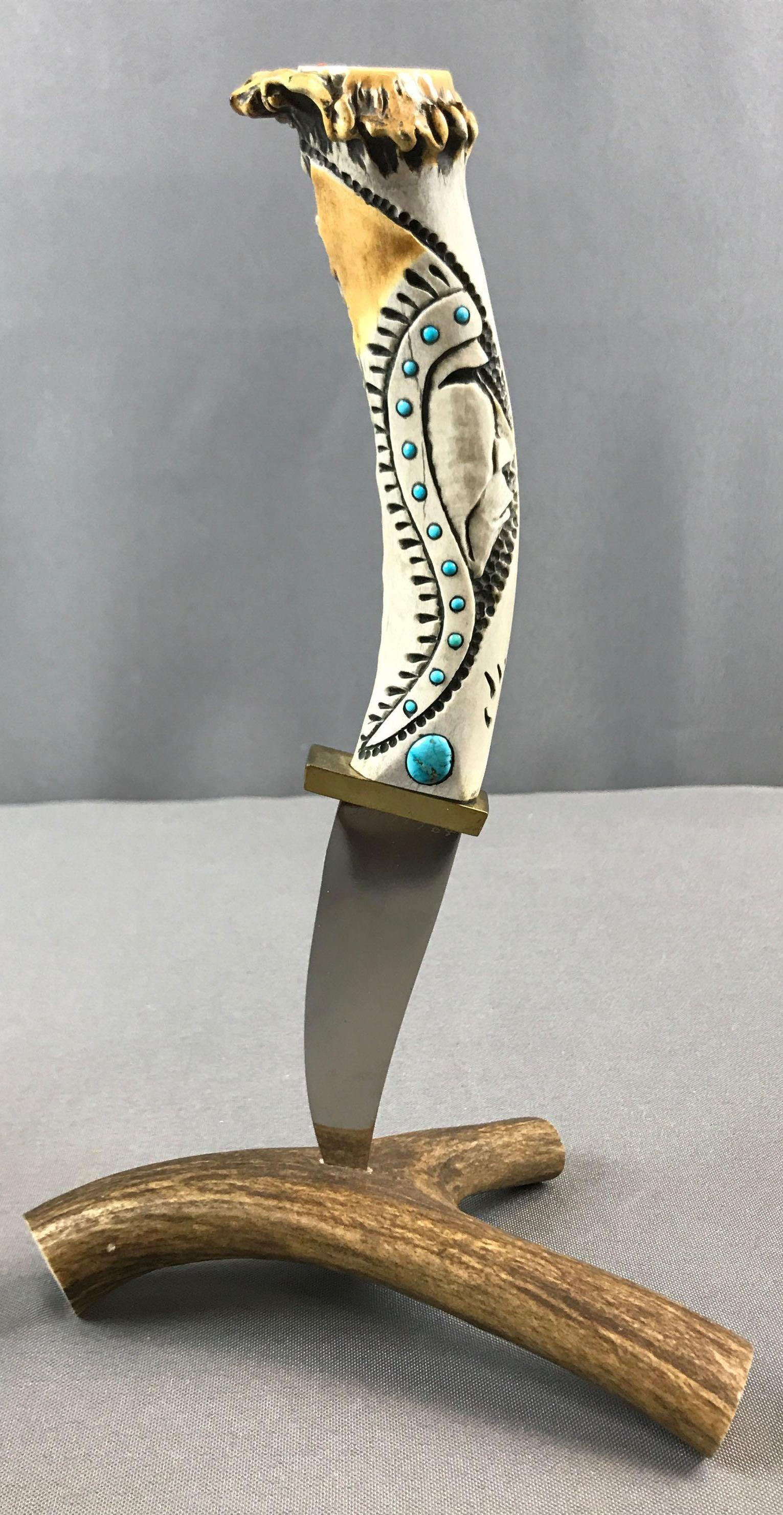 Ted Miller Carved Handle Knife with Antler Stand: Turquoise in handle. Eagle on top. Total height in stand 10 inches.