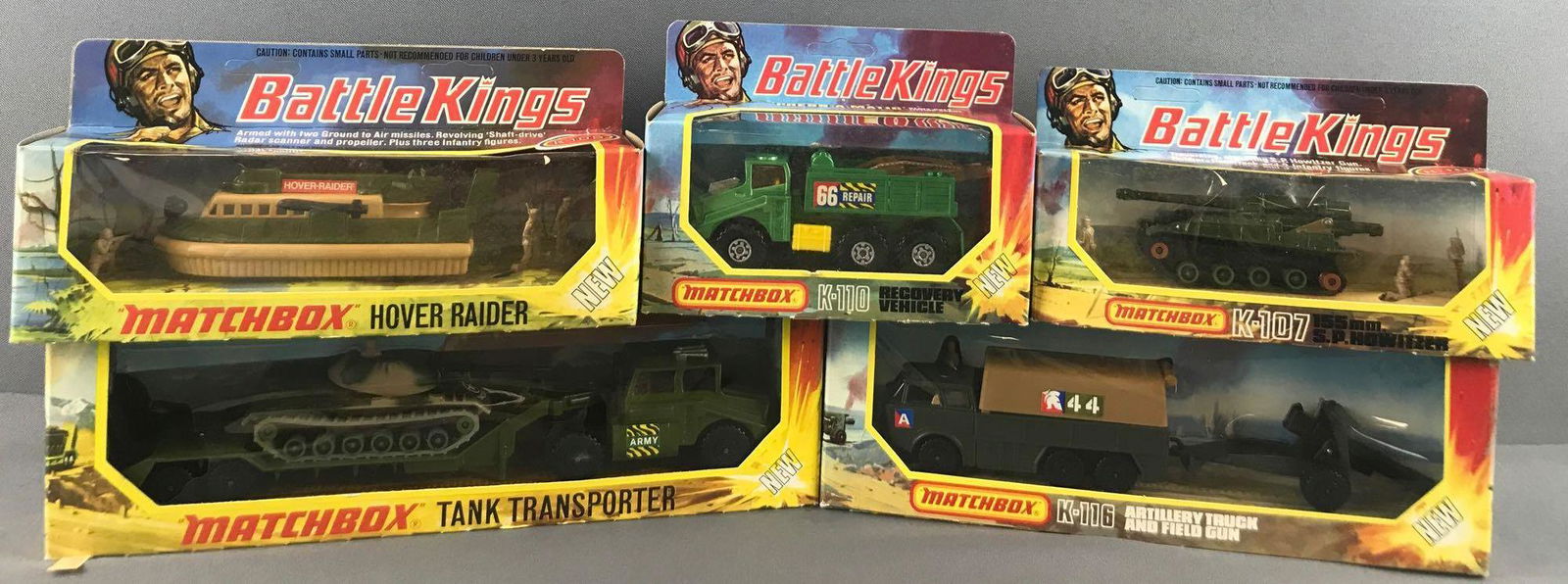 Group of 5 Matchbox Battle Kings Die-Cast Vehicles in: Includes K-105 Hover Raider, K-110 Recovery Vehicle, K-107 155mm S.P. Howitzer, K-116 Artillery Truck and Field Gun, and K-106 Tank Transporter, New in Original Packaging, A Lesney Product, Made in En