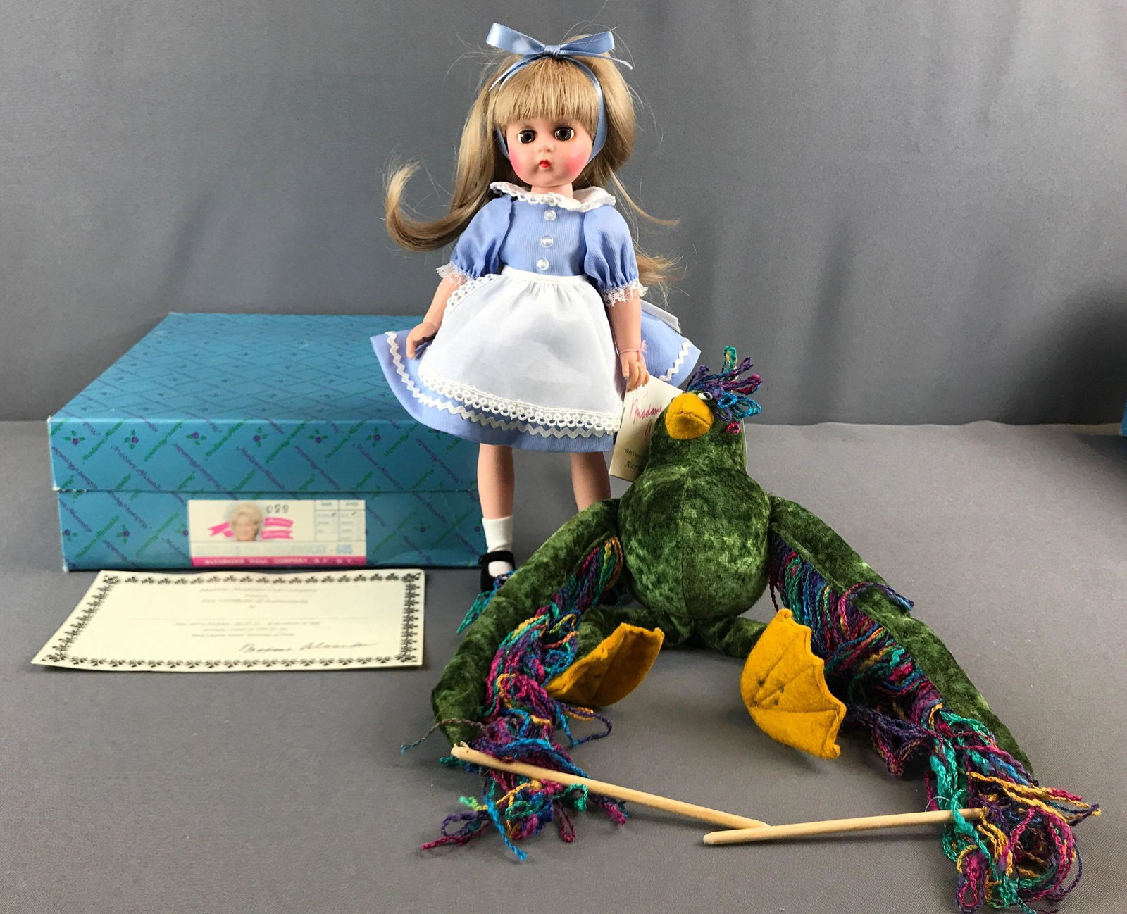 Madame Alexander Alice and the Jabberwocky doll in: 12 inch, #60S, 1993 for the Walt Disney World Showcase of Dolls. Numbered 99/500 with COA.