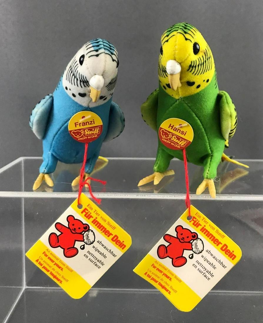 Group of 2 1970s Steiff Parakeets: Airbrushed velveteen and felt with rubber beaks and wings. Hansi 2531/13 and Franzi 2534/13 are 4 inches tall and 9 inches long. With all original tags. Hansi has some staining on face/head. Out of bo