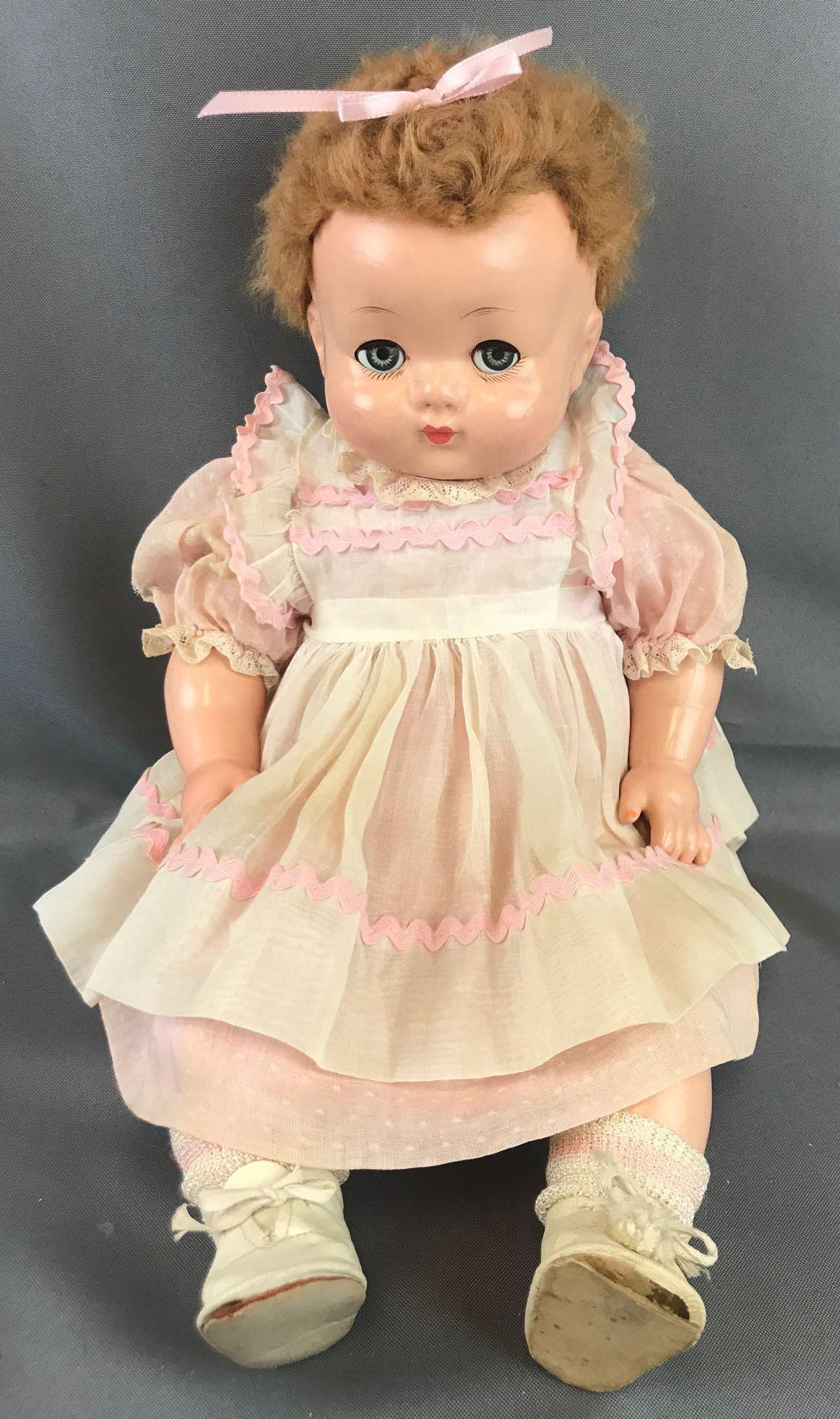 Vintage 1940s Effanbee doll: 19 inches. Sweetie Pie. Sleepy eyes that also move side to side. Molded hair underneath wig. Surface cracks. Markings on upper legs from melted rubber pants, per previous owner.