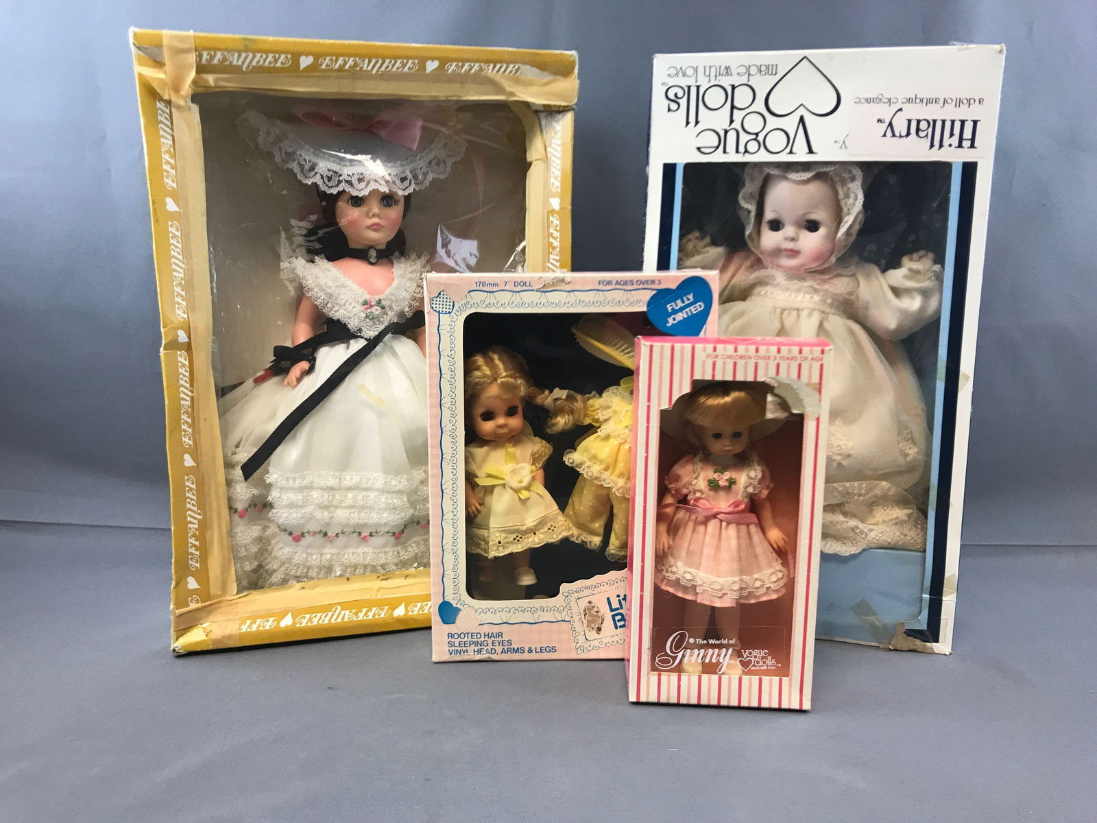 Group of four vintage dolls in original packaging: Effanbee, Hillary Vogue doll. Largest box measures 12 x 17. All boxes show some wear. Circa 1970s