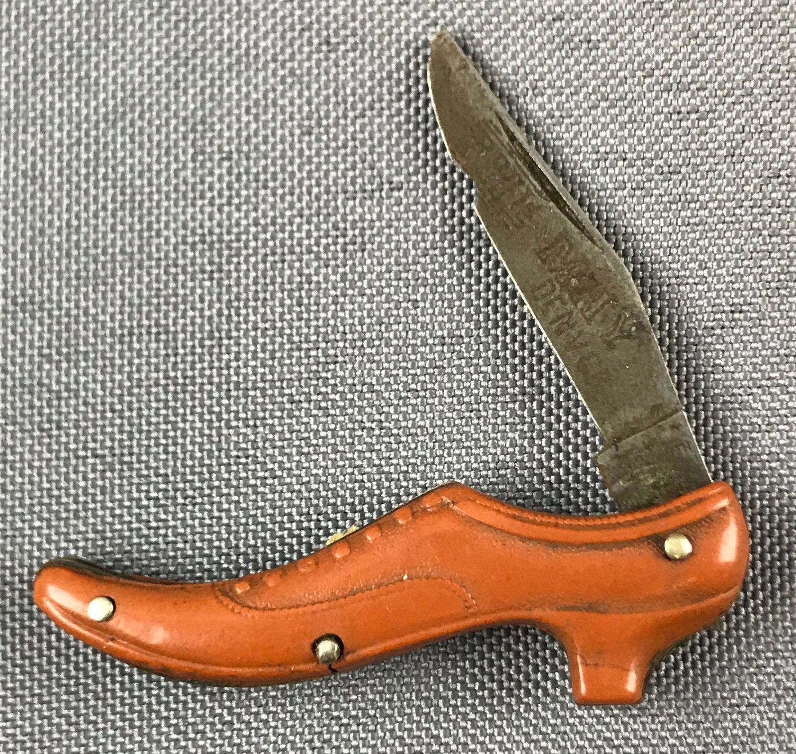 Vintage Pocket Knife shaped like shoe: Knife says The May Denver. 2 inches closed. Blade and case both have some damage and wear.