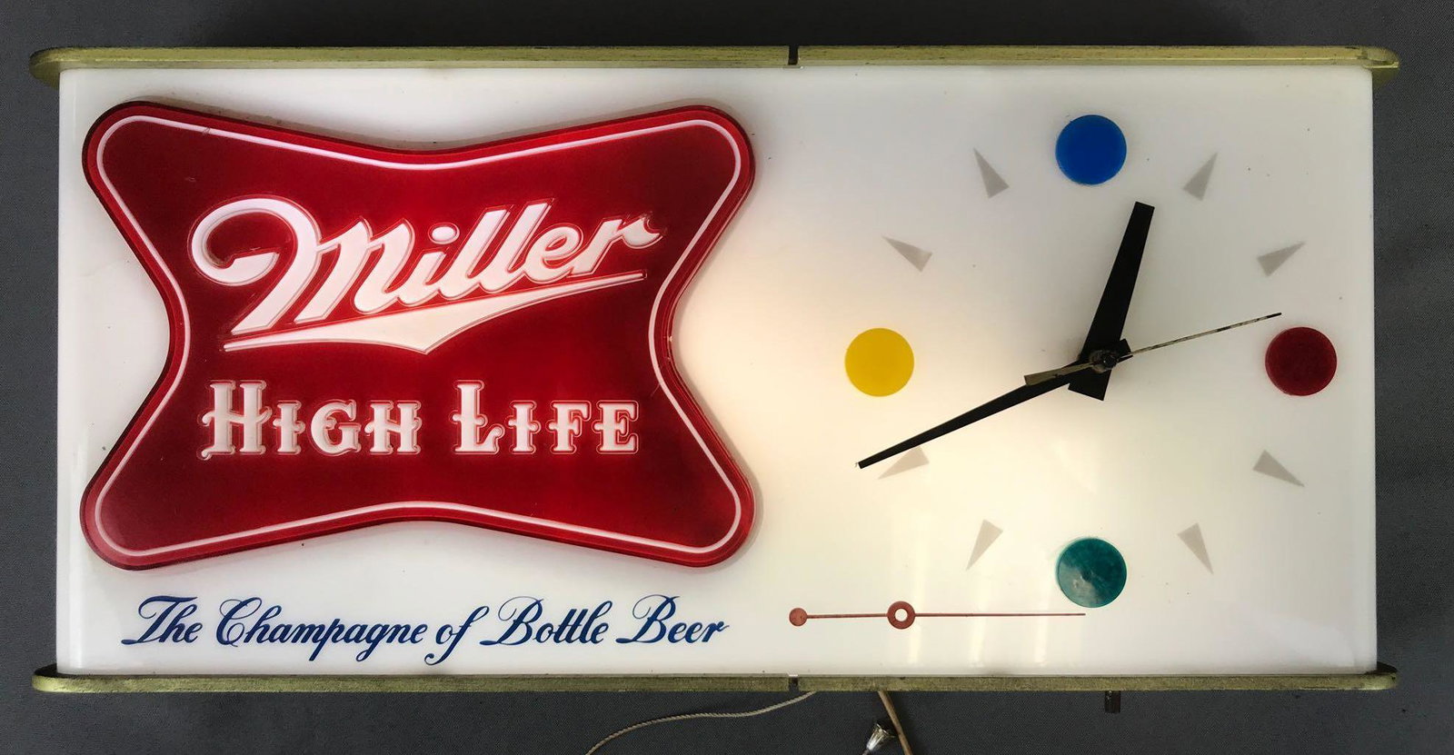 Miller High Life Advertising clock/light.: 20 x 3 x 9. One loose hand on clock. Working condition, some damage